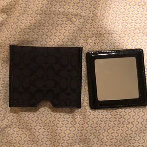 Coach mirror with pouch